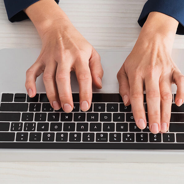 Woman typing on a keyboard